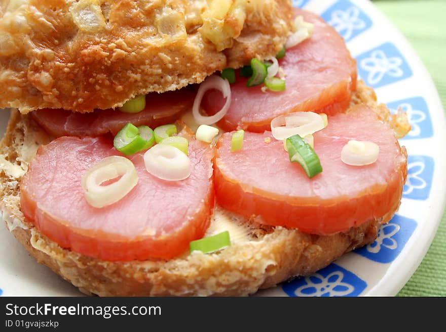 A fresh cheesebread with ham and onions. A fresh cheesebread with ham and onions