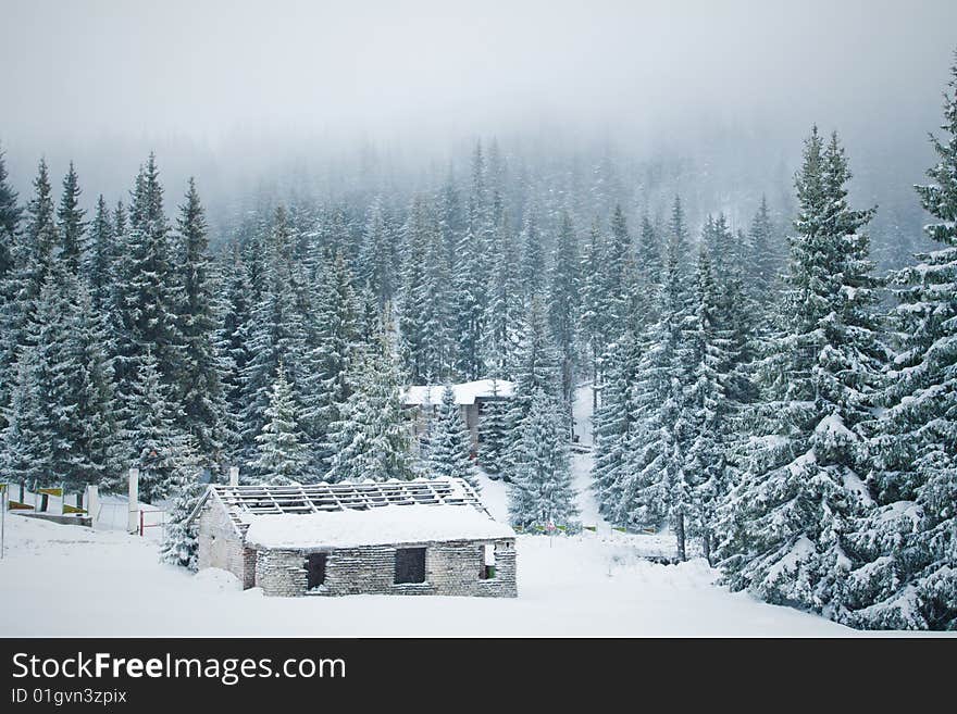 Old shabby house in the snowy mountain forest. Old shabby house in the snowy mountain forest