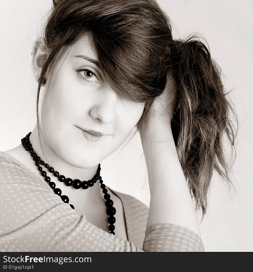 Young pretty girl holsing her hair on white background. Young pretty girl holsing her hair on white background