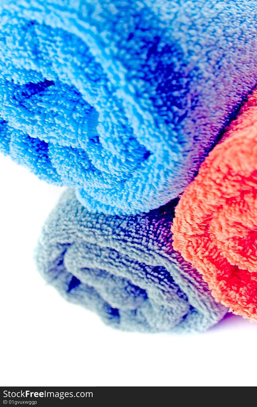 Colorful towels over closeup on white background