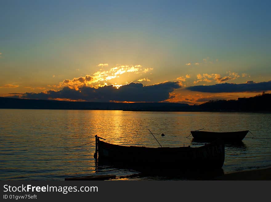 Varna beach at sunset.The fishing boats and the black sea. Varna beach at sunset.The fishing boats and the black sea.