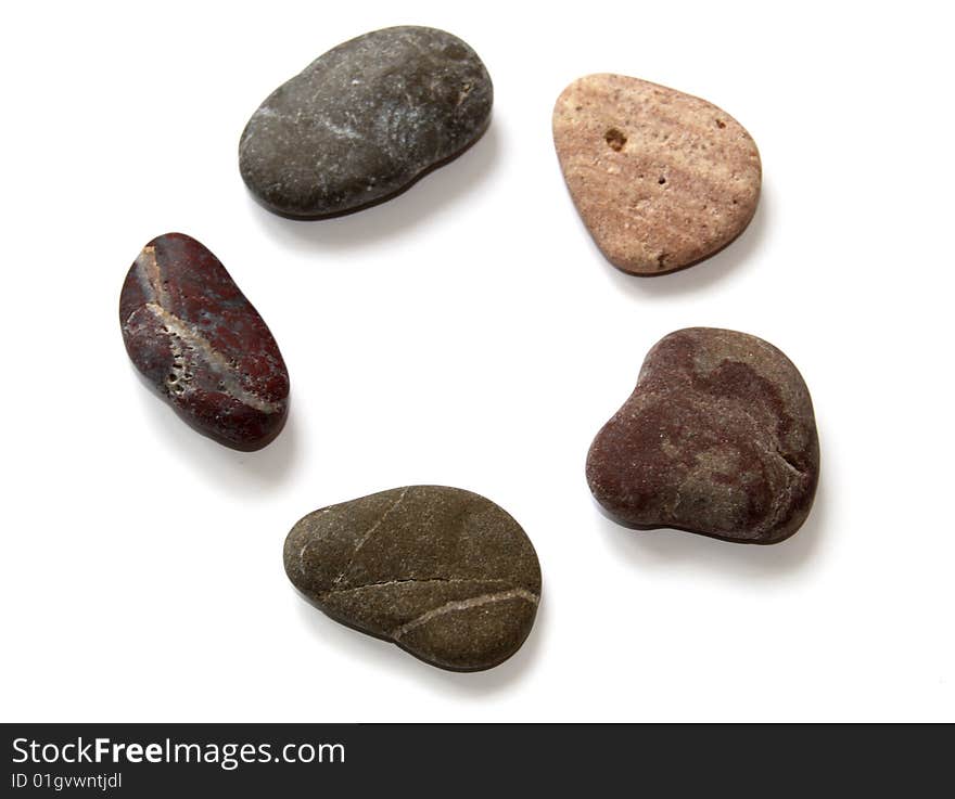 Close-up colored stones for spa procedures on a white. Close-up colored stones for spa procedures on a white.