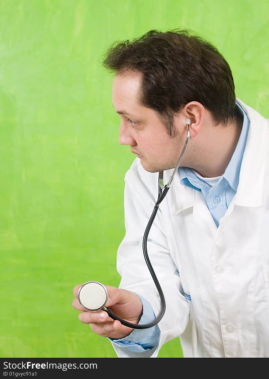 Doctor,green wall, face and stethoscope