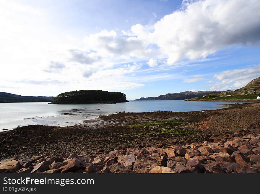 Shieldaig's Beach (Scotland) by a sunny summer day with white clouds, at low tide. Shieldaig's Beach (Scotland) by a sunny summer day with white clouds, at low tide.