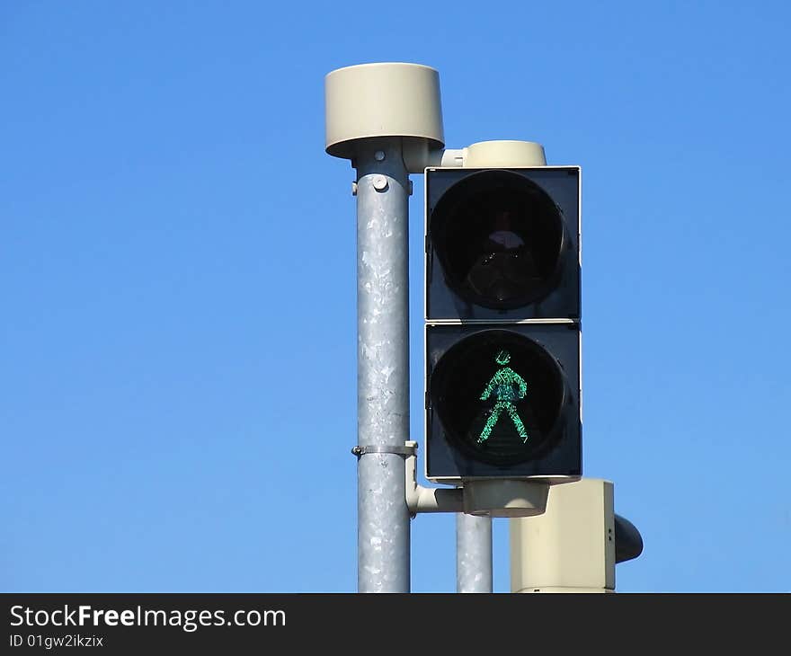 Detail of traffic lights for pedestrians with green sign for walk. Detail of traffic lights for pedestrians with green sign for walk.