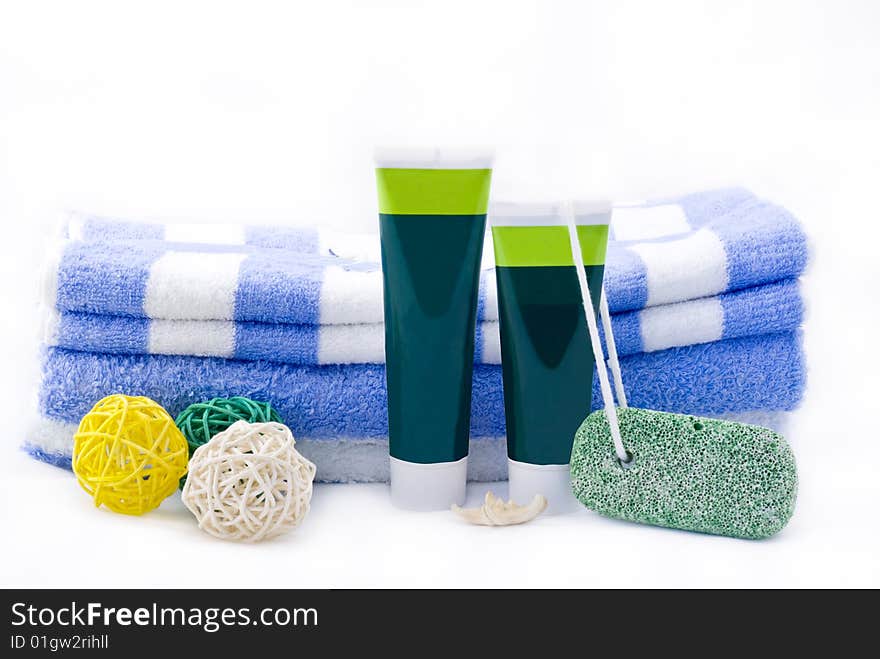 Striped towels with creams isolated on white background