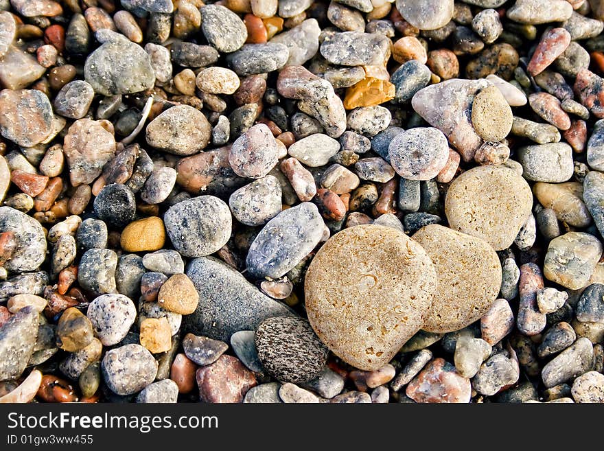 Abstract background of colorful pebbles on beach