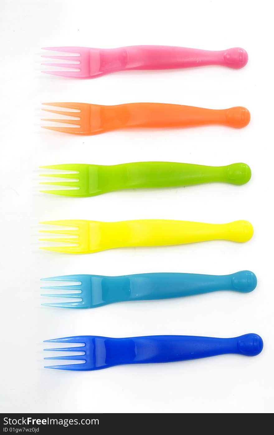 Colorful plastic forks on white. Colorful plastic forks on white