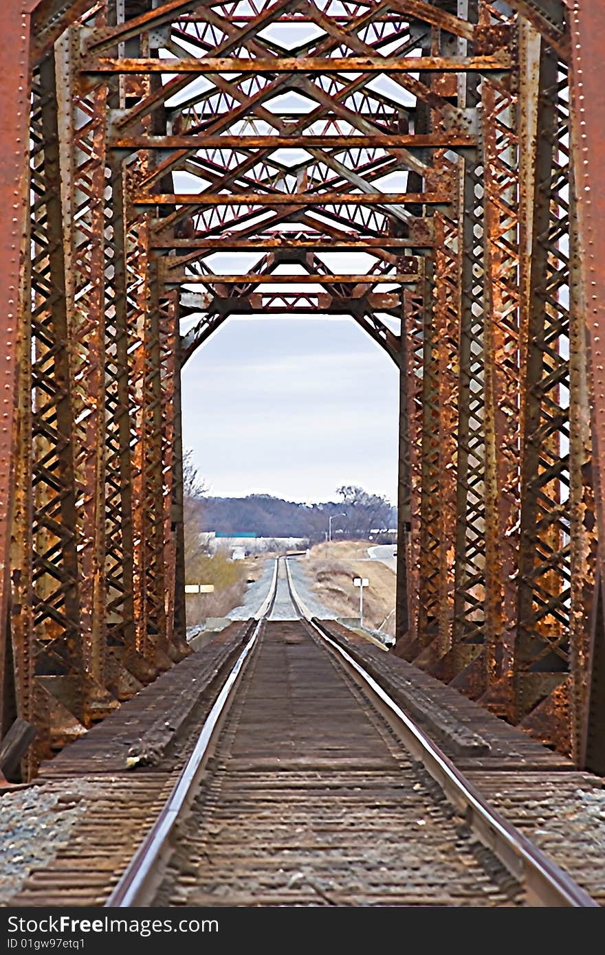 Old rusted railroad bridge with tracks and railroad ties