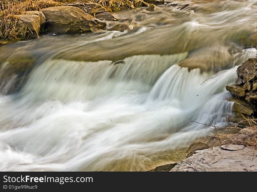 Fast moving running water from a lake running over rocks. Fast moving running water from a lake running over rocks