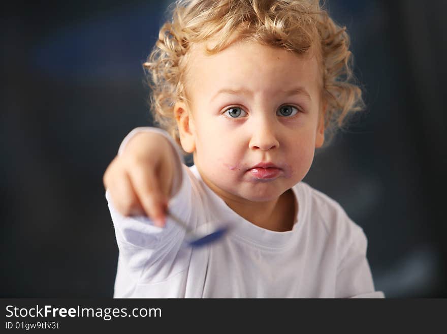 Portrait of the little boy eating yogurt. Portrait of the little boy eating yogurt