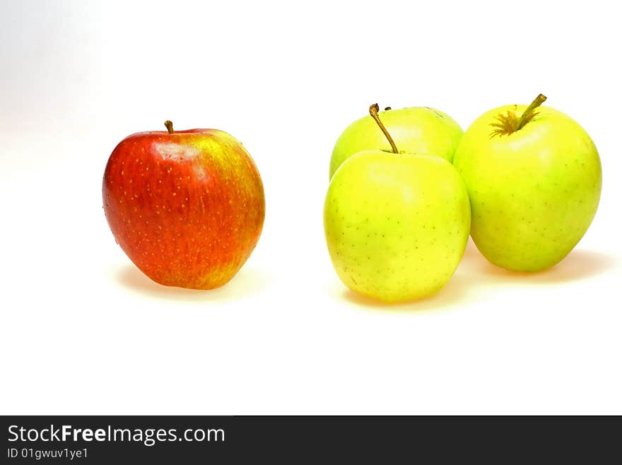 Single red apple with a group of green apples. Single red apple with a group of green apples