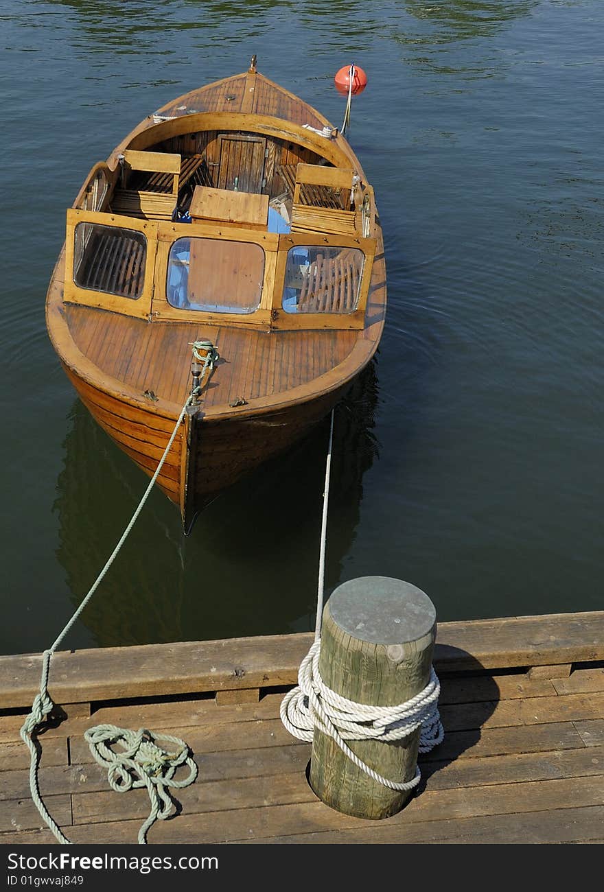 Small Boat Tied To Dock