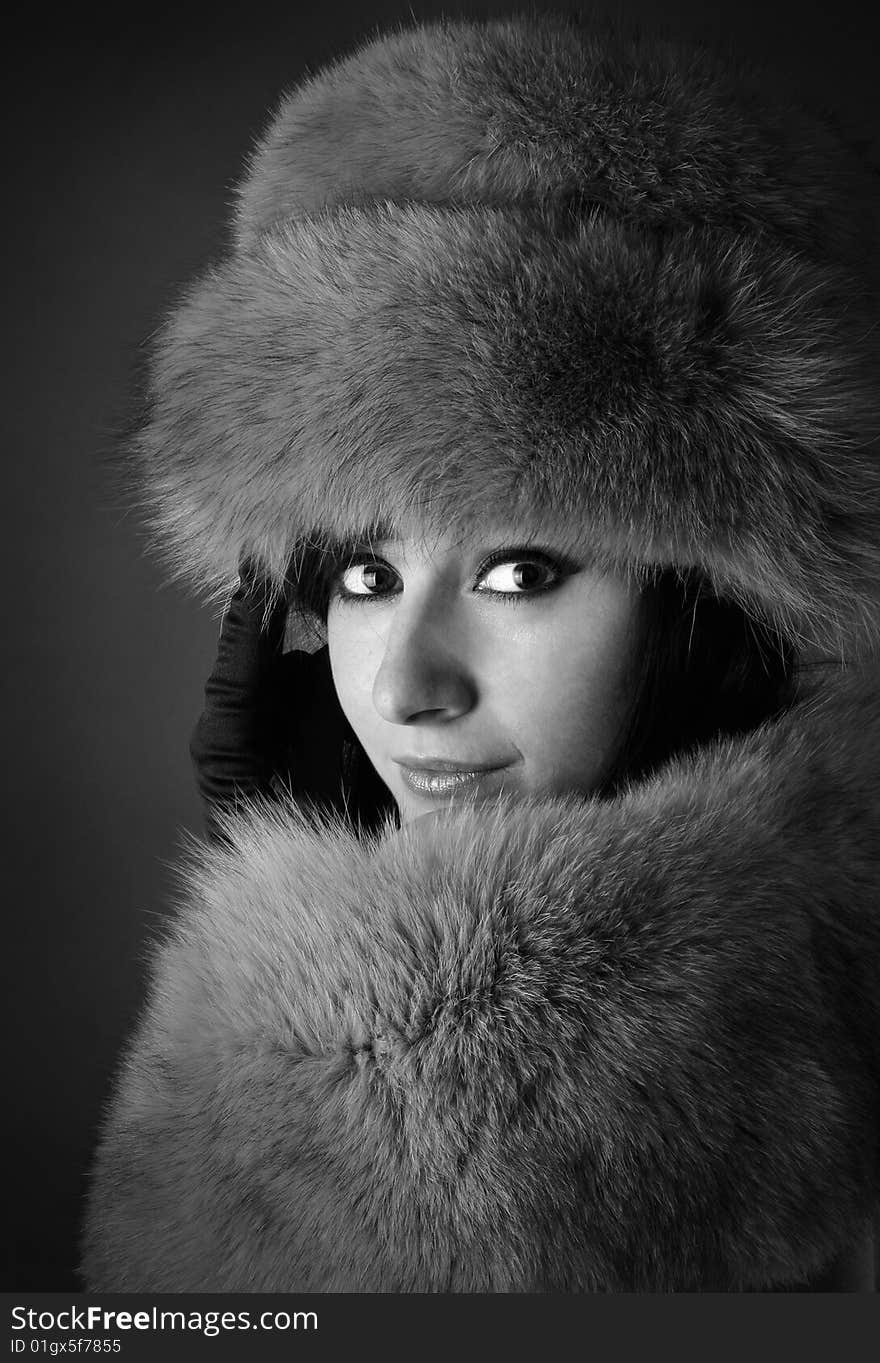 Portrait of young beautiful brunette on a darck background