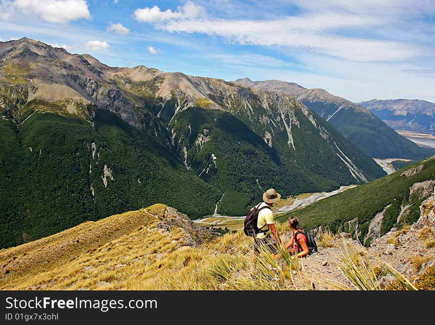 Couple climbing Avalanche peak enjoying the scenic