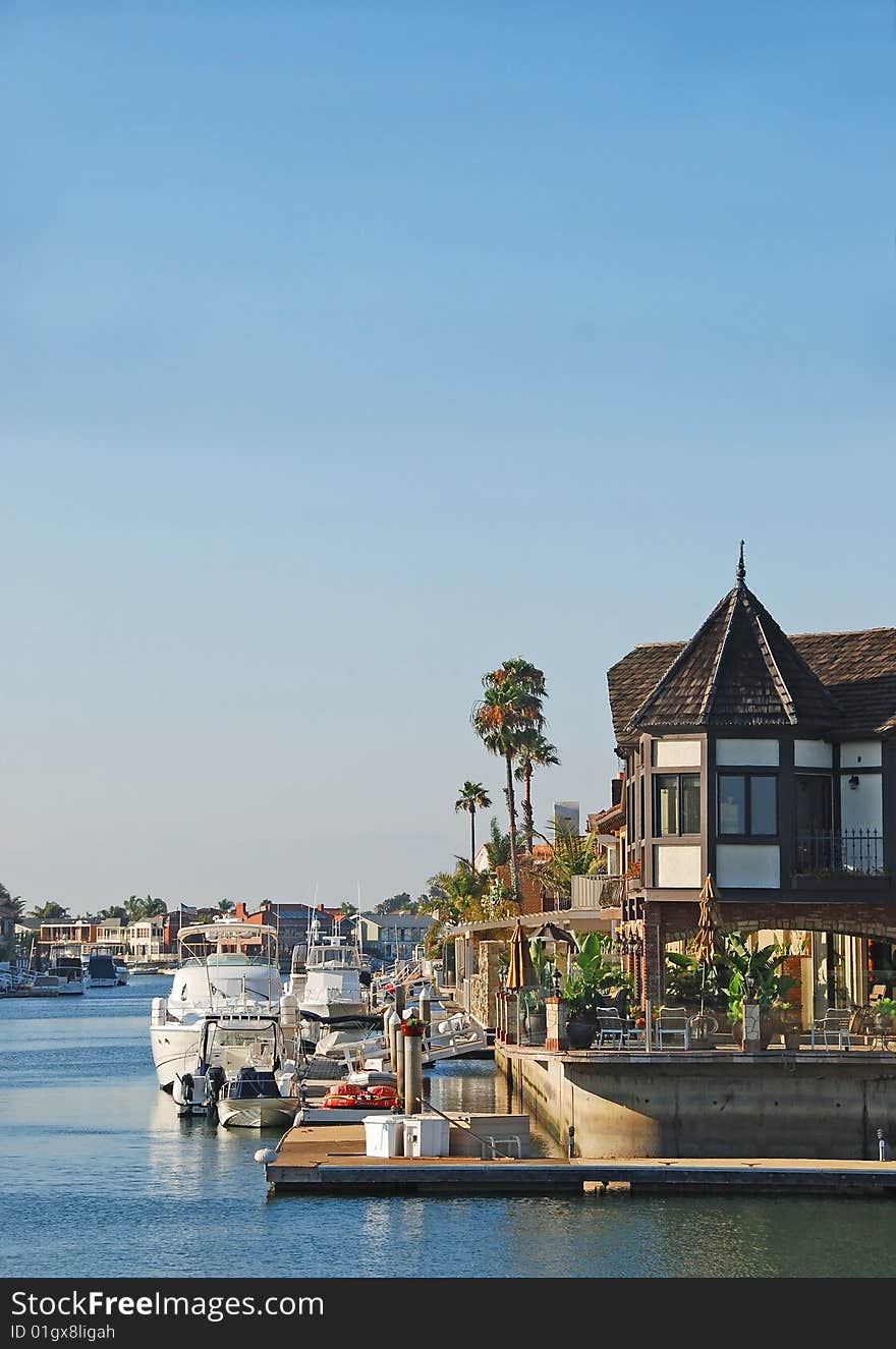 A luxury house on the water side with a boat. A luxury house on the water side with a boat