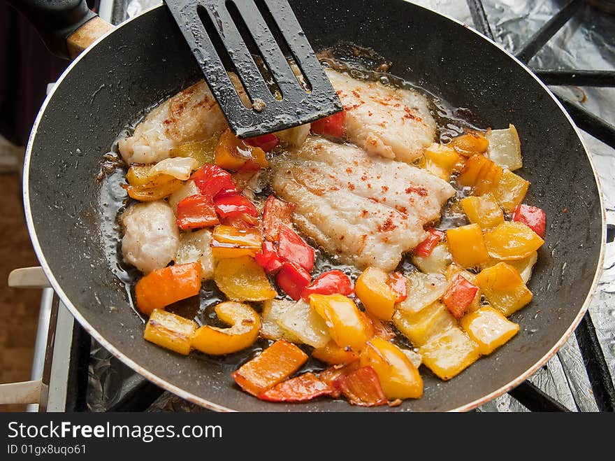 Pangasius filet frying with yellow peppers. Pangasius filet frying with yellow peppers