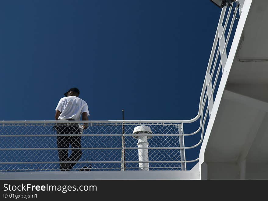 Man Leans On Ferry Railing