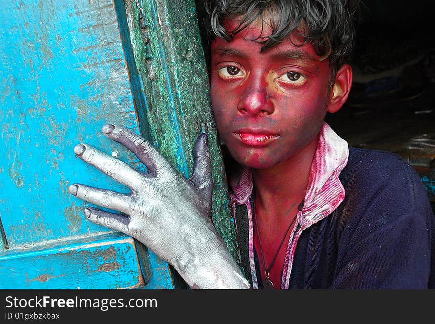 Close up of a boy’s face smeared with colour during the Holi festival in India.