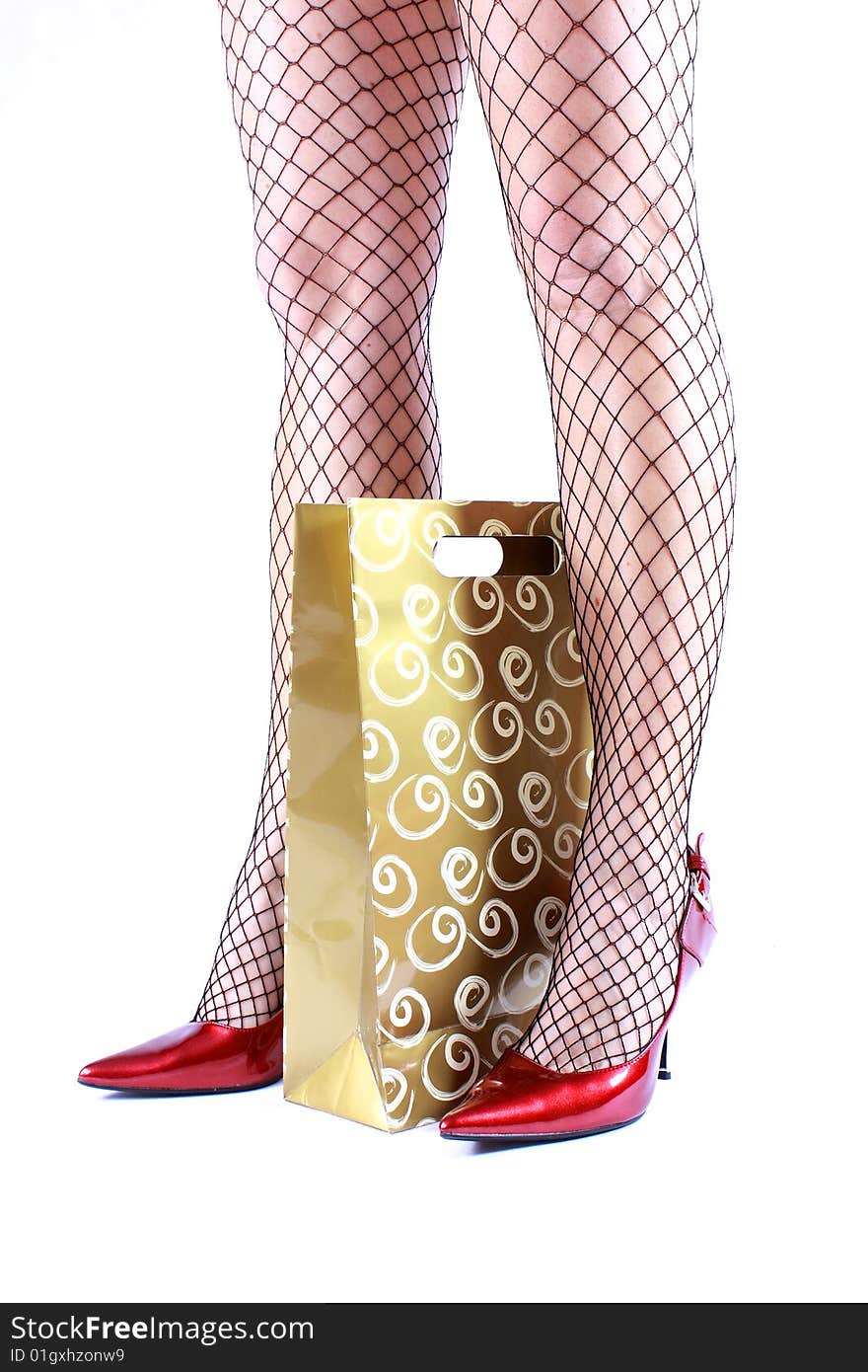 Sexy Female Legs With Stockings And Red Heels And Shopping Bag