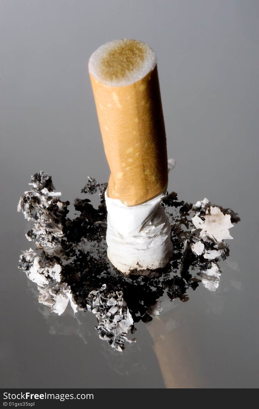 Cigarette stub on grey background