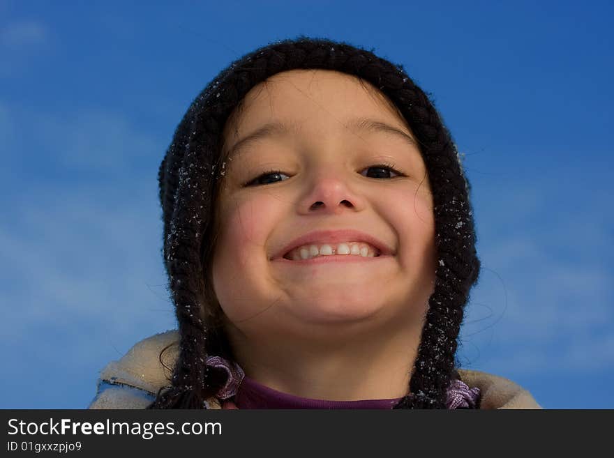 Cute girl winter portrait with blue sky