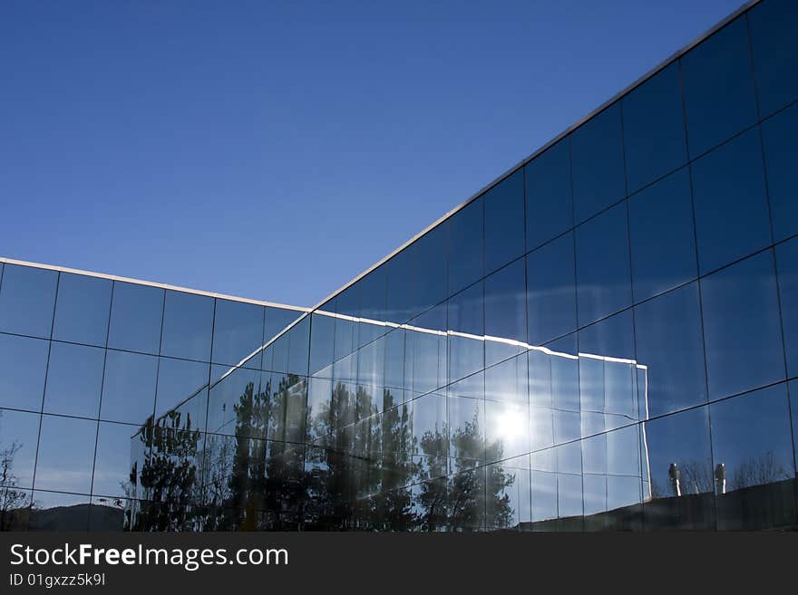 Reflections of the sun in the glass of the modern building.