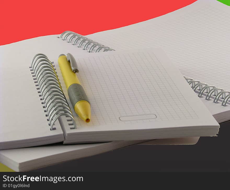 An open notebook with pencil on a white background