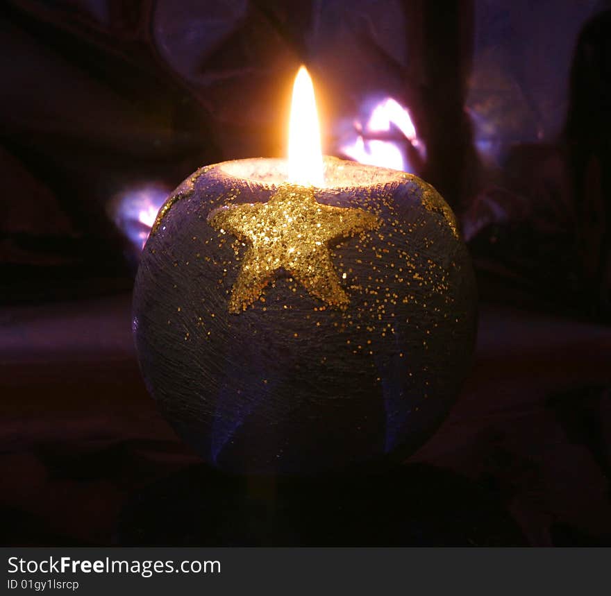 Candle with star in the dark