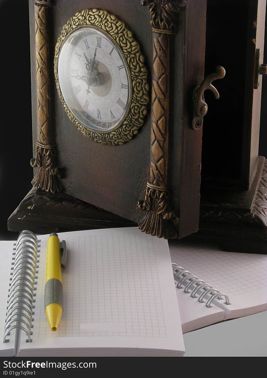 Clock and notebook on grassland. Clock and notebook on grassland