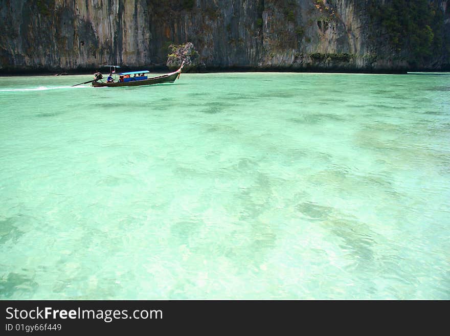 The boat crossing blue sea. The boat crossing blue sea