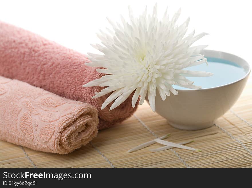 Towels and white flower isolated. spa and body care