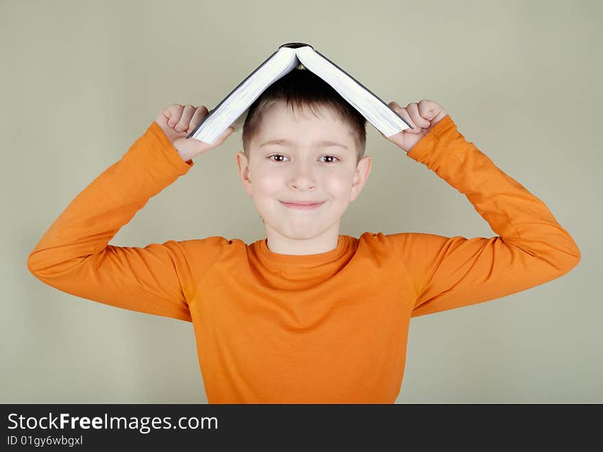 Boy with a book on her head