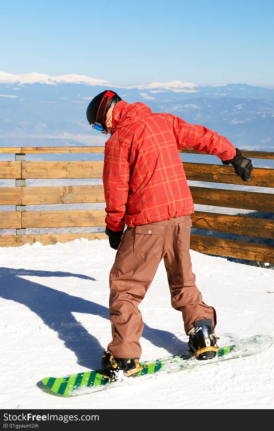 Snowboarder - young man on the ski slope. Snowboarder - young man on the ski slope