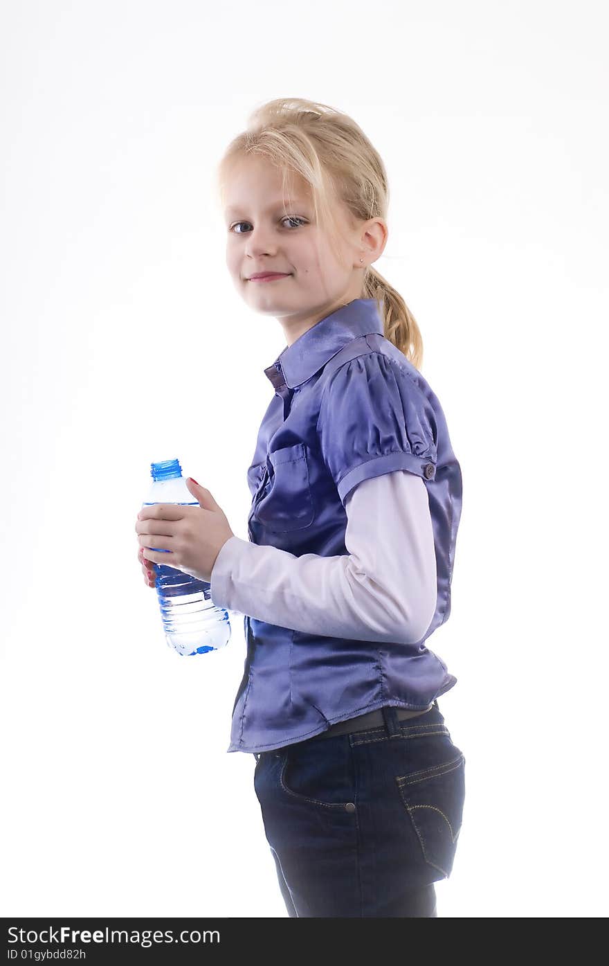 Little pretty young smiling  girl with bottle fresh water on a white studio background. Little pretty young smiling  girl with bottle fresh water on a white studio background.