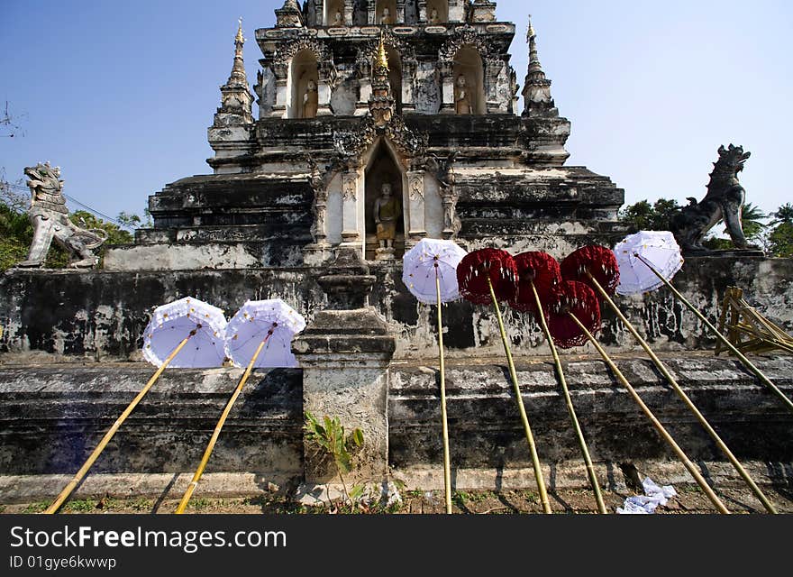 Thailand, the Wat Ku Kan situated in the region of Chiang Mai was founded in a shallow fertile bassin. view of the main chedi of wat chedi liam with parasols. Thailand, the Wat Ku Kan situated in the region of Chiang Mai was founded in a shallow fertile bassin. view of the main chedi of wat chedi liam with parasols