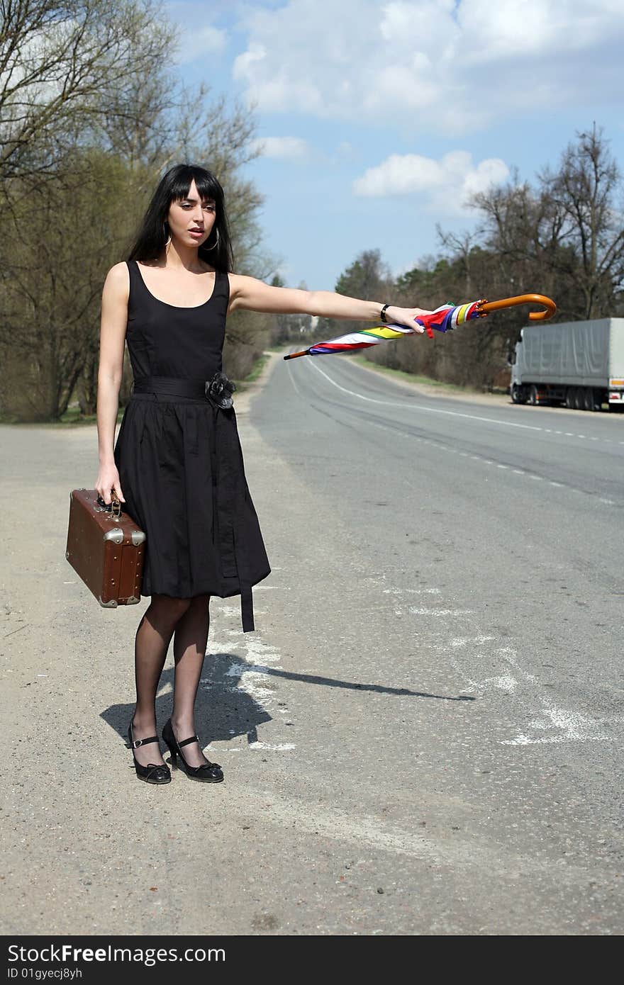 Girl with vintage suitcase and umbrella outdoors. Girl with vintage suitcase and umbrella outdoors