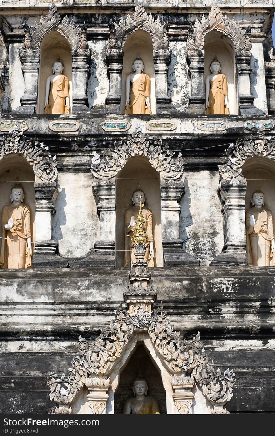 Thailand, the Wat Ku Kan situated in the region of Chiang Mai was founded in a shallow fertile bassin. view of the main chedi of wat chedi liam with buddha image inside the niches. Thailand, the Wat Ku Kan situated in the region of Chiang Mai was founded in a shallow fertile bassin. view of the main chedi of wat chedi liam with buddha image inside the niches