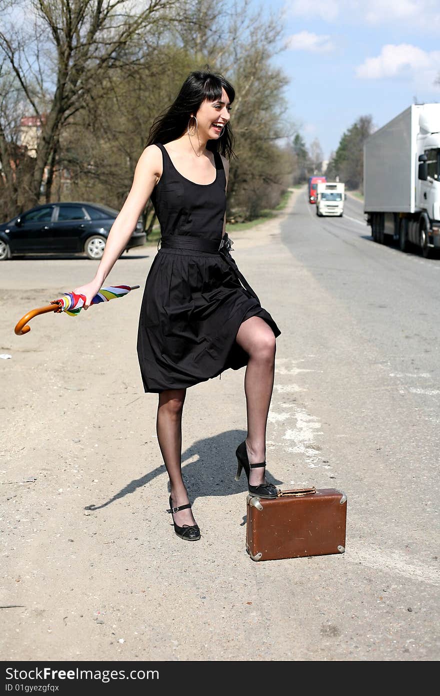 Girl with vintage suitcase and umbrella outdoors. Girl with vintage suitcase and umbrella outdoors