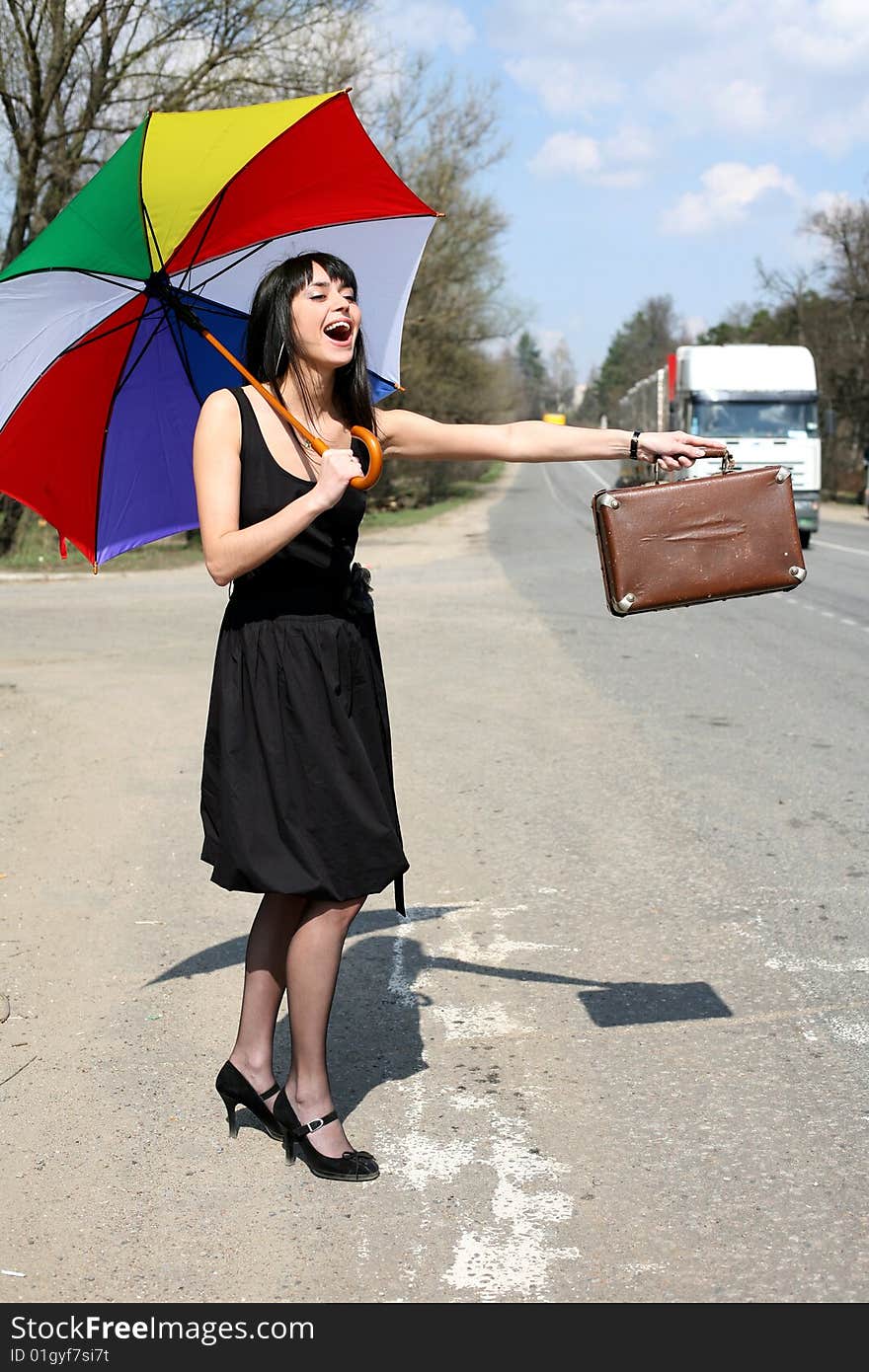 Girl with vintage suitcase and umbrella outdoors. Girl with vintage suitcase and umbrella outdoors