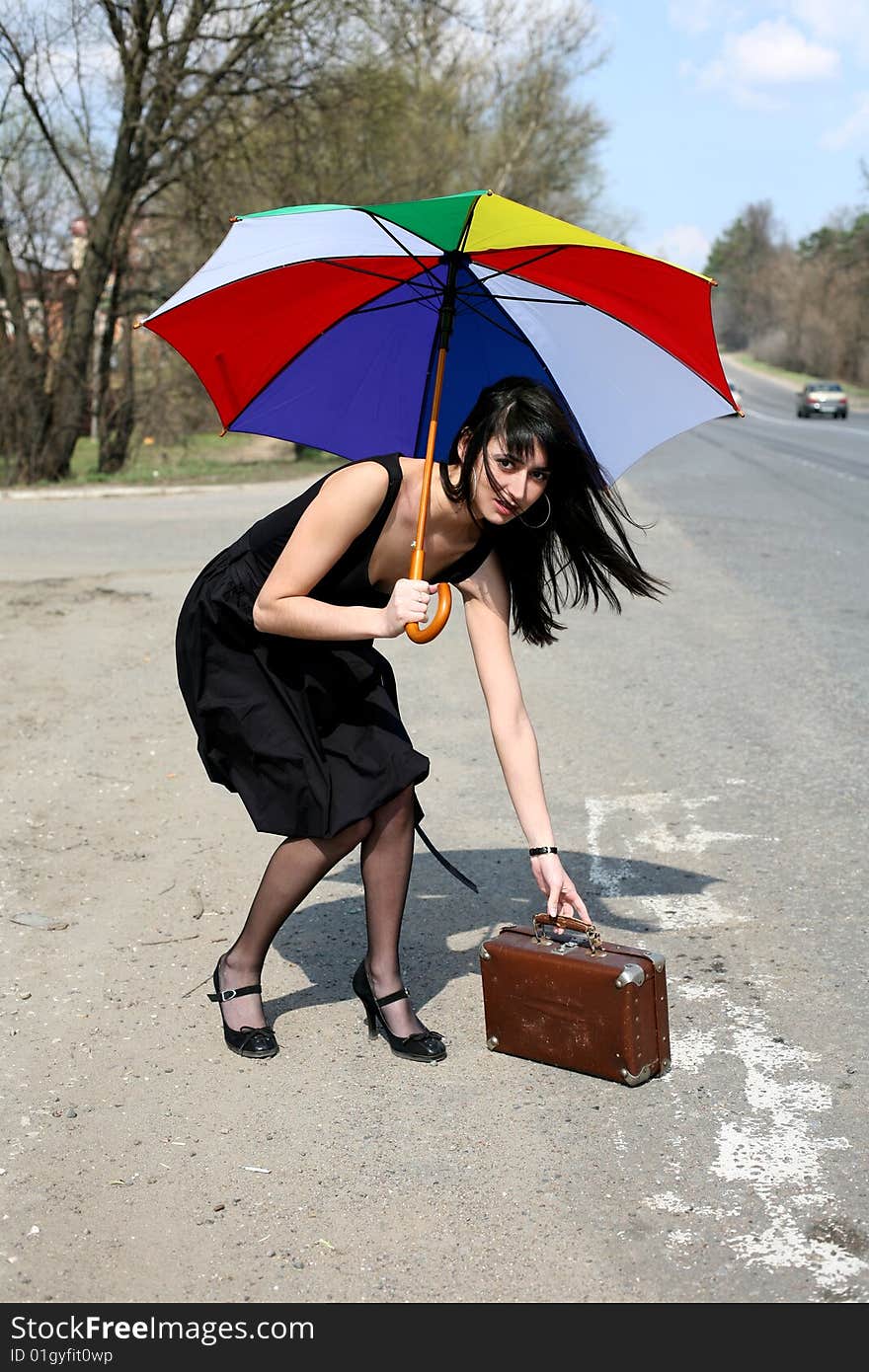 Girl with vintage suitcase and umbrella outdoors. Girl with vintage suitcase and umbrella outdoors