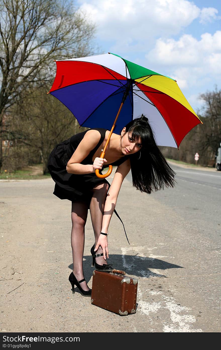 Girl with vintage suitcase and umbrella outdoors. Girl with vintage suitcase and umbrella outdoors