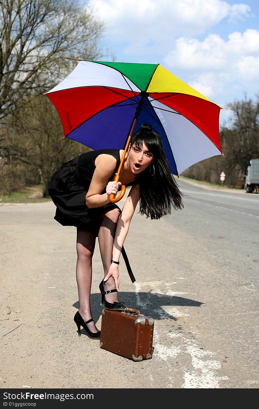 Girl with vintage suitcase and umbrella outdoors. Girl with vintage suitcase and umbrella outdoors