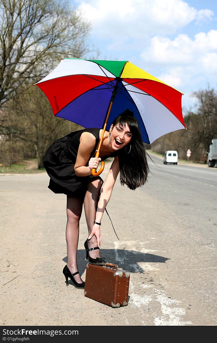 Girl with umbrella at road. Girl with umbrella at road