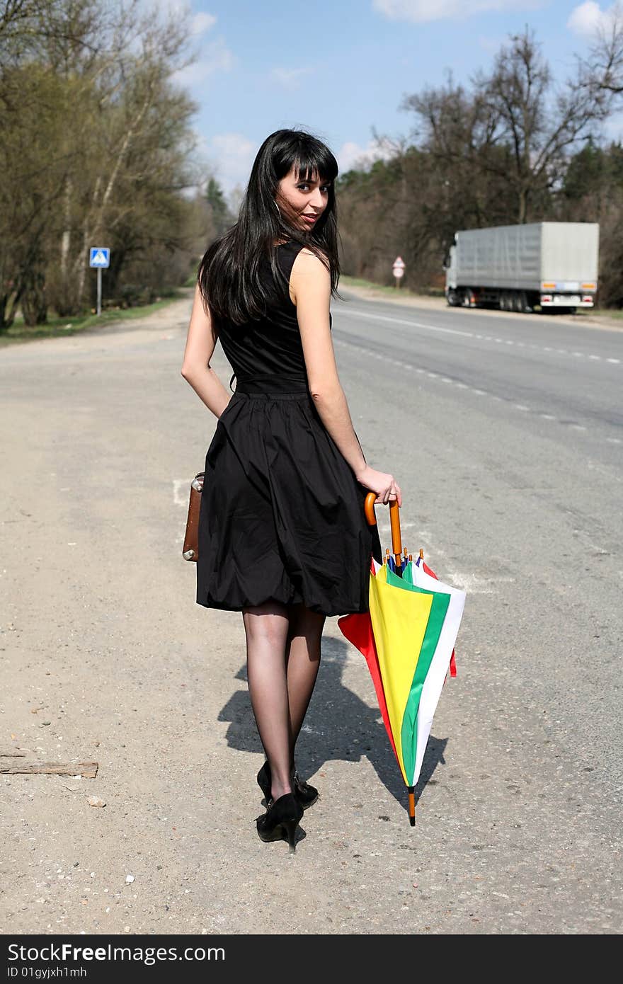 Girl with vintage suitcase and umbrella outdoors. Girl with vintage suitcase and umbrella outdoors