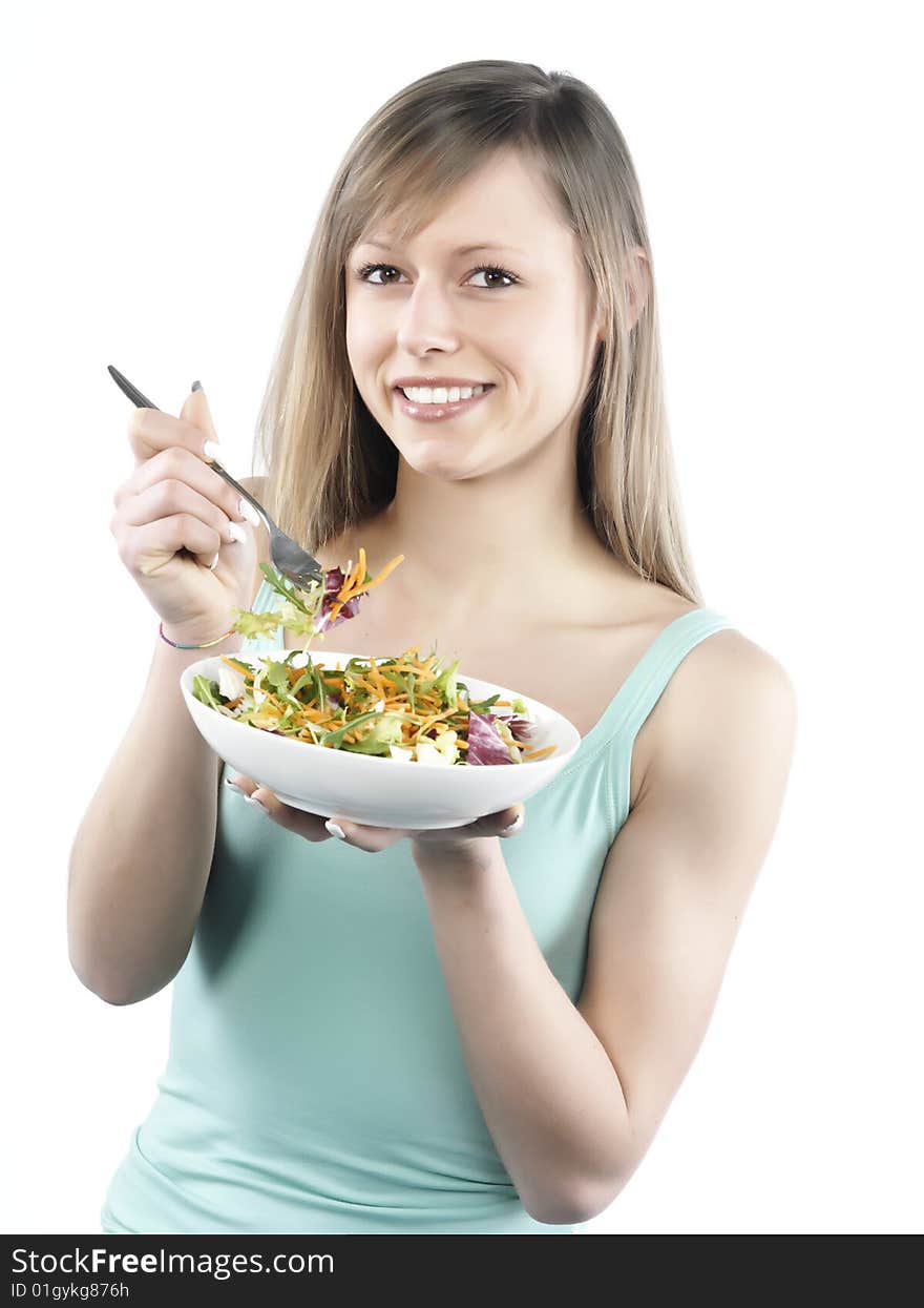 Portrait of young happy woman eating salad