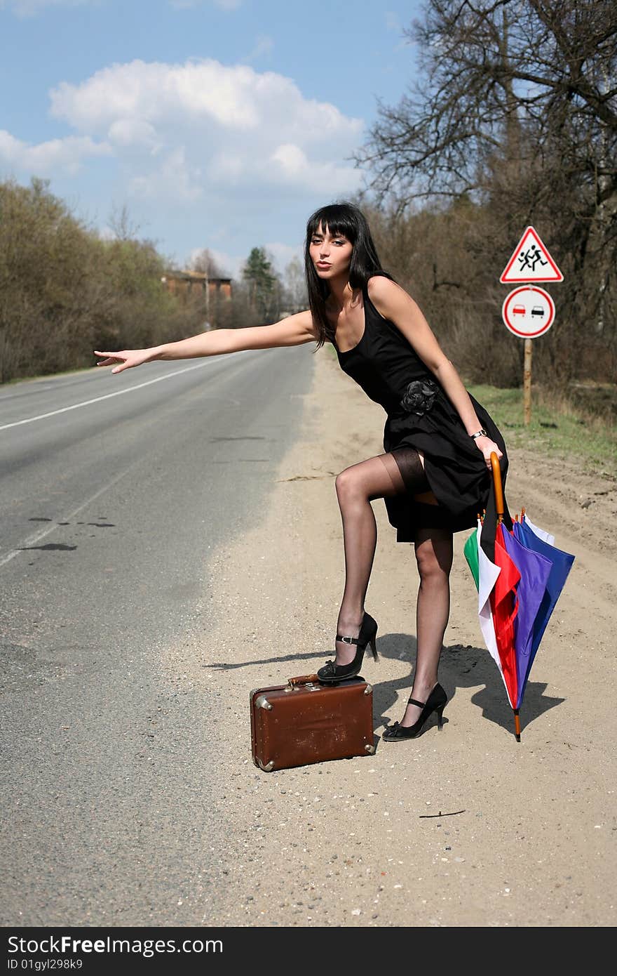 Girl with vintage suitcase and umbrella outdoors. Girl with vintage suitcase and umbrella outdoors