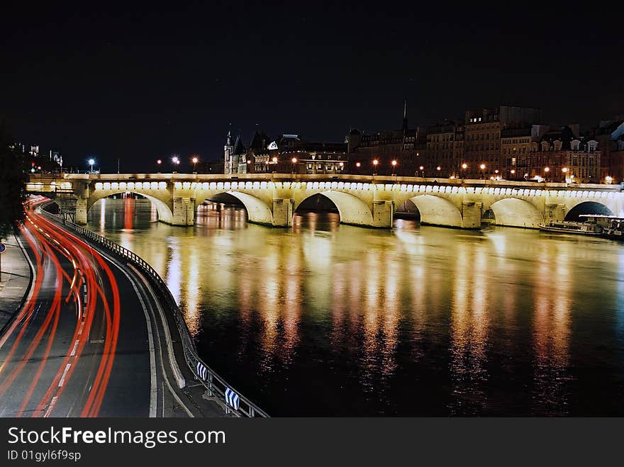 Night sight of Paris with the Conciergeri to the bottom and traffic llghts in the first term of the image. Night sight of Paris with the Conciergeri to the bottom and traffic llghts in the first term of the image