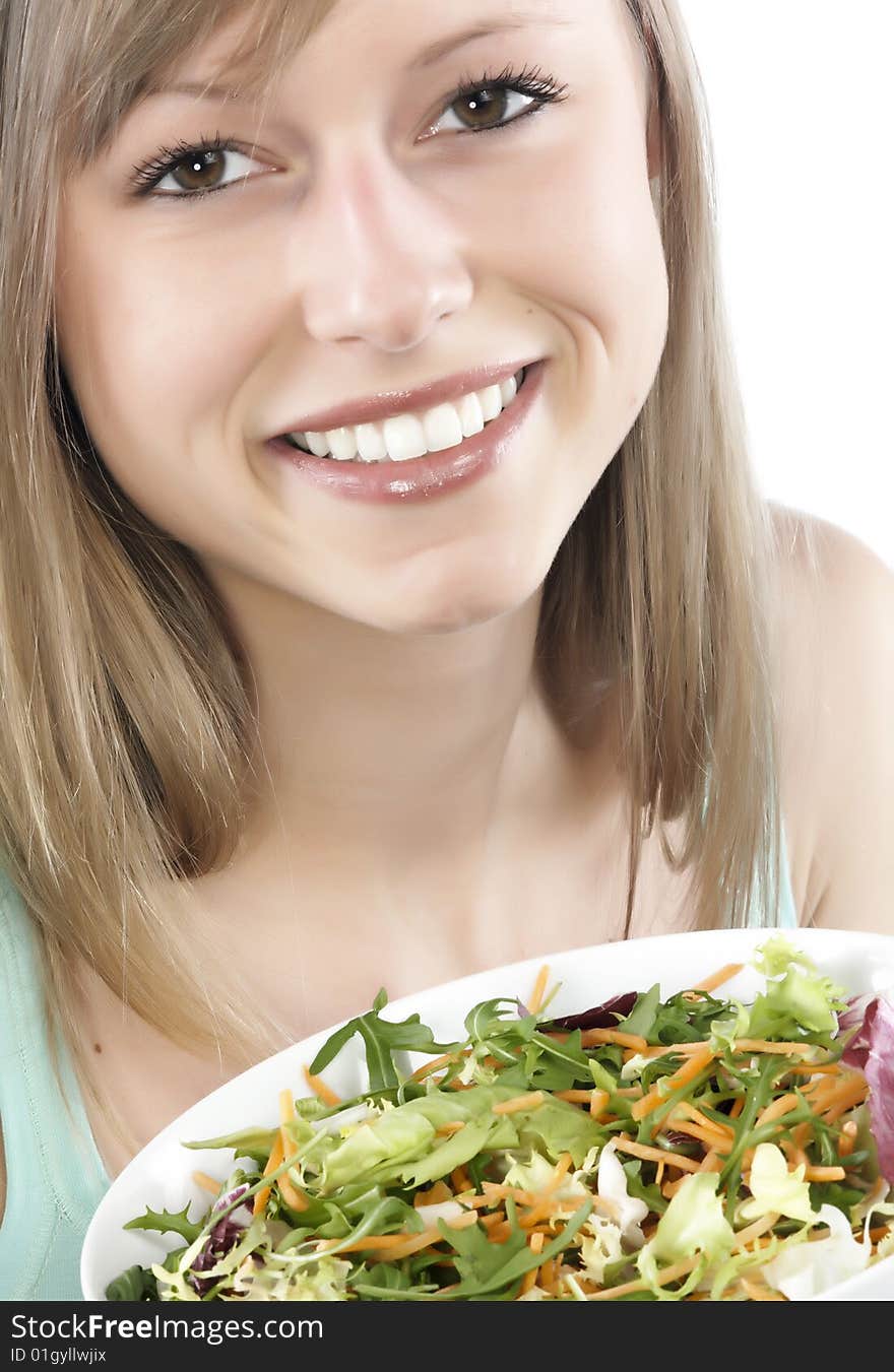 Portrait of young happy woman eating salad