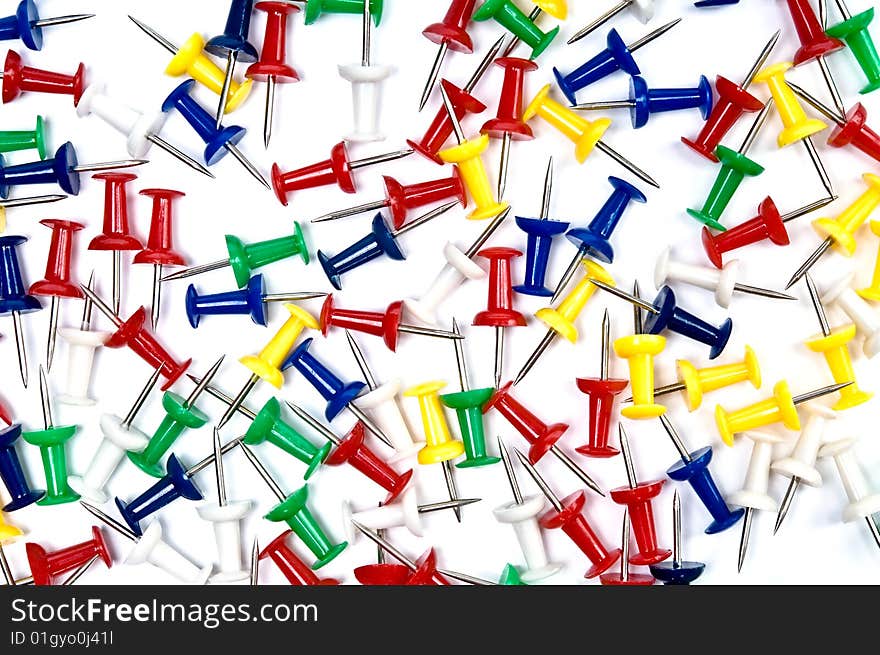 Colorful pins over the white background